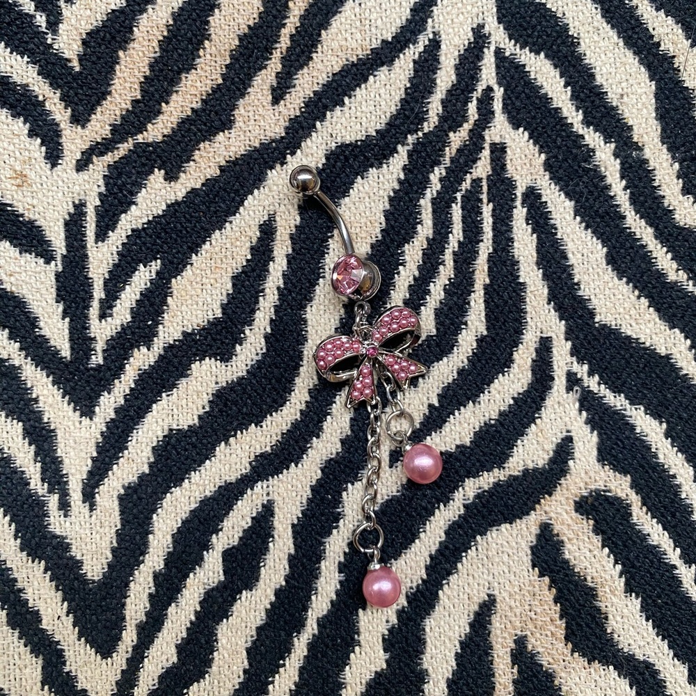 dangly pink bow belly button ring piercing
